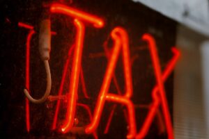neon sign saying Tax
