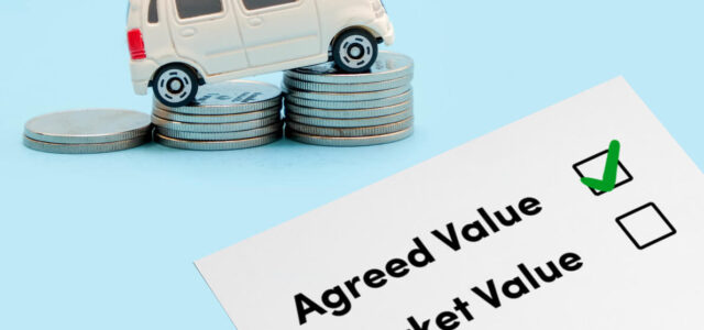 Agreed Value tick. Toy car driving over coins